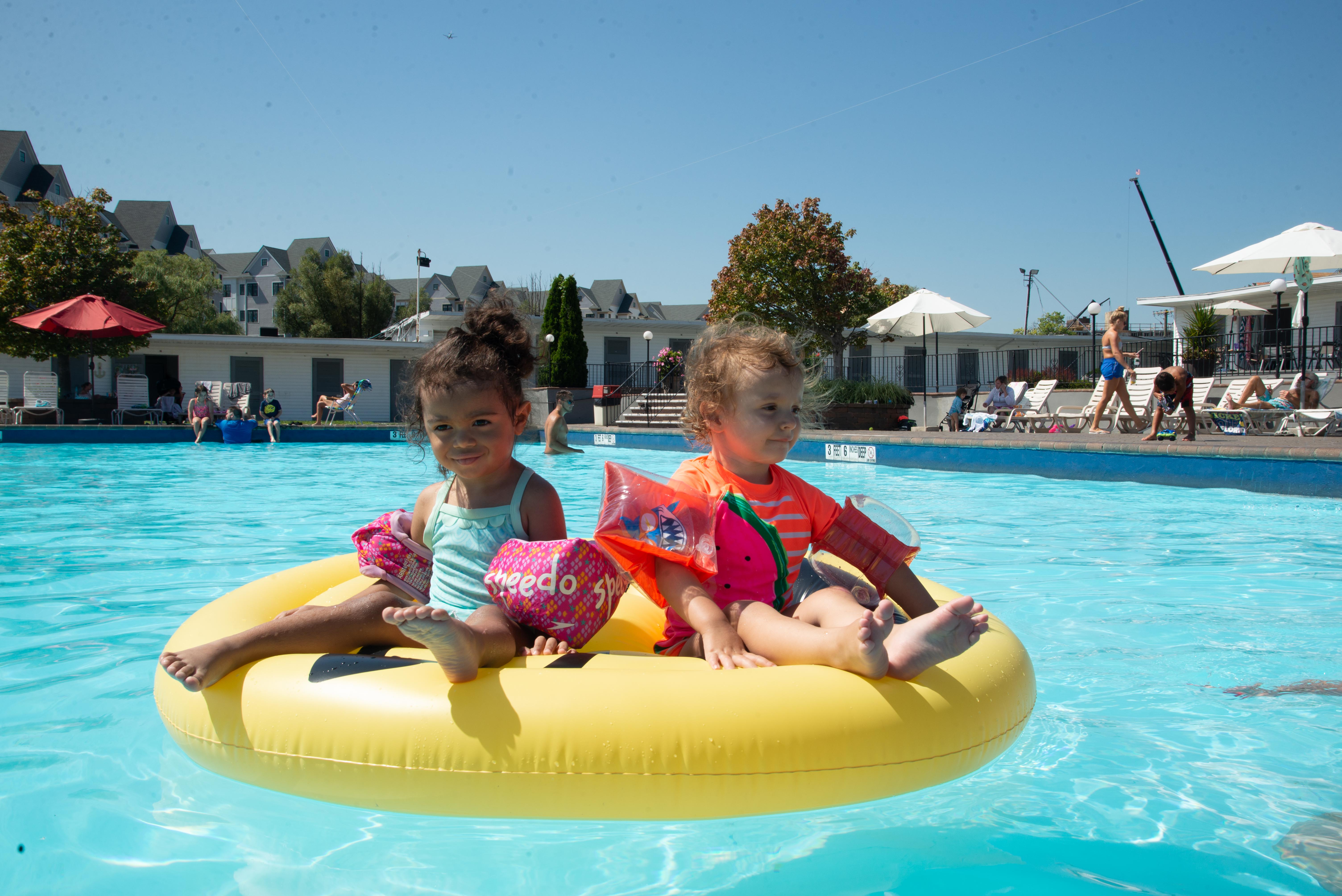 children on tube in pool