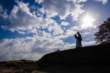 sillouette of bride and groom on hill