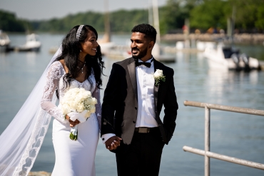 bride and groom walking on the pier