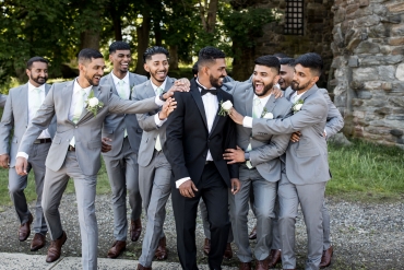 groomsmen laughing with groom