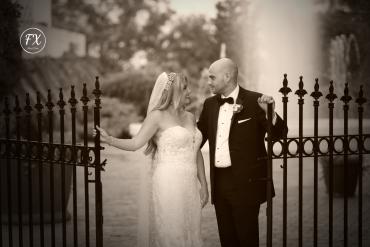 newlyweds walking out of picket fence