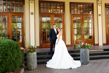 bride and groom posing at entrance