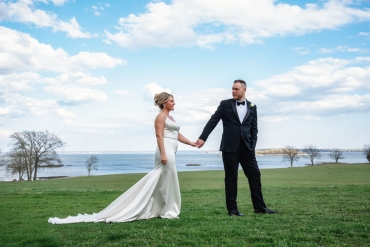 bride and groom taking a stroll along long island sound