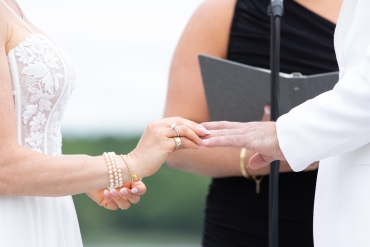 bride putting ring on groom