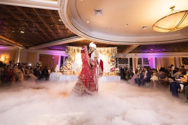 indian couple dancing with fog on ground