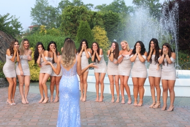girls laughing in front of fountain 