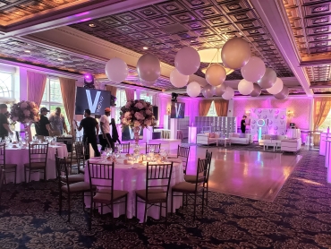 special event with balloons on ceiling and pink lighting