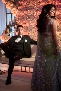 groom relaxing while bride poses