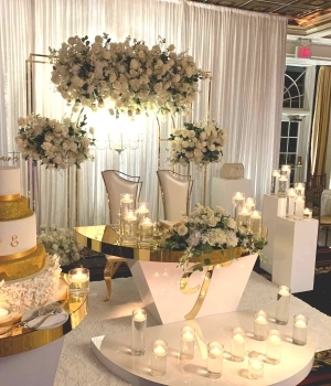 cake table with flowers surrounding cake