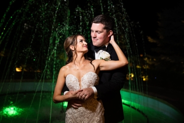 wedding pose in front of green fountain lighting