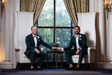groomsmen sitting on extra tall chairs