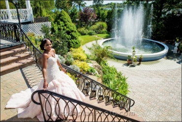 bride coming down back stairs with fountain in background