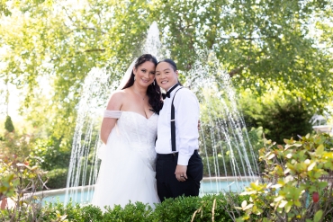 couple by front fountain greenery