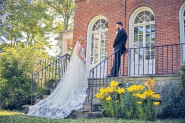 couple in front of brick house