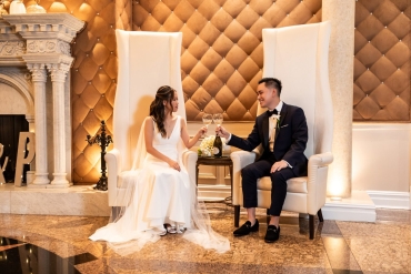 celebratory drinks at vip's luxurious high back chairs in front of fireplace