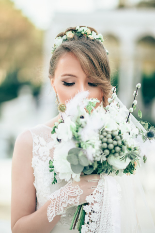 bride smelling wedding flowers